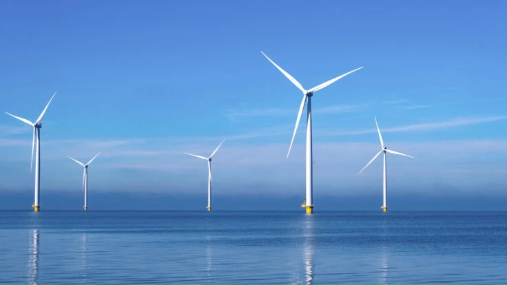Offshore Windmill Park With Clouds And A Blue Sky